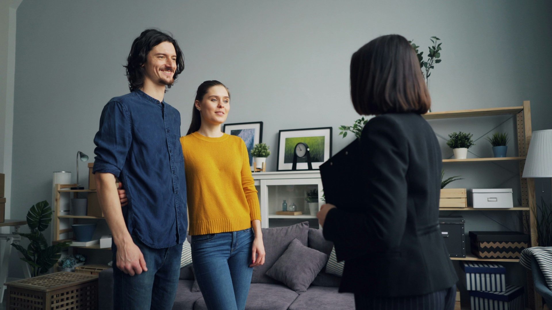 a group of people standing around a living room