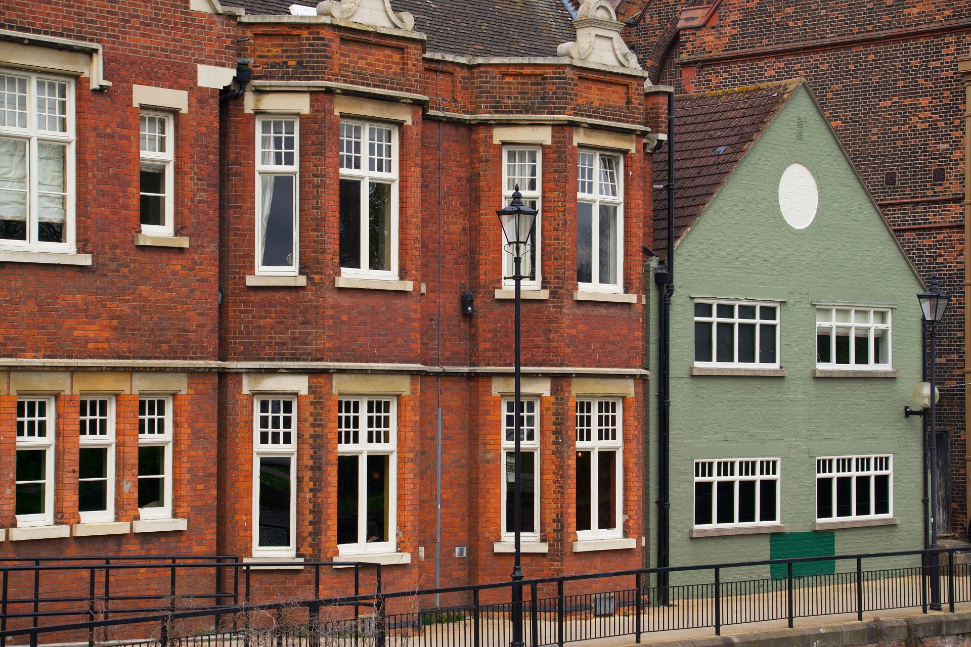 View of classic red brick buildings with bay windows in Bedford, England.