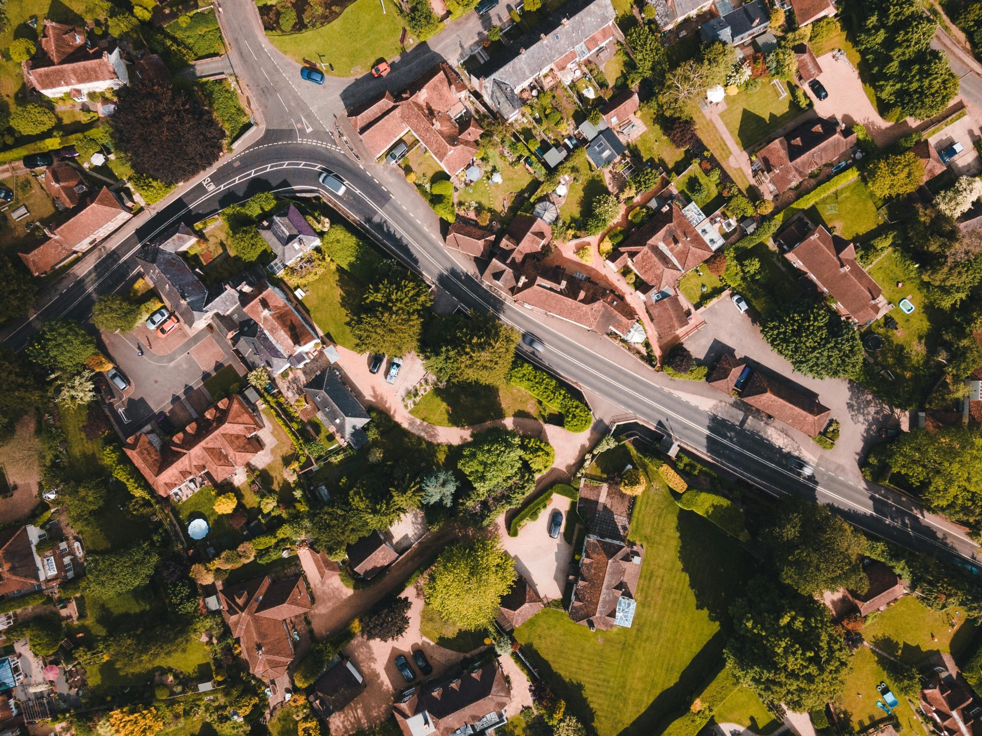 Aerial photo capturing the lush greenery and rooftops of Singleton, England on a sunny day.
