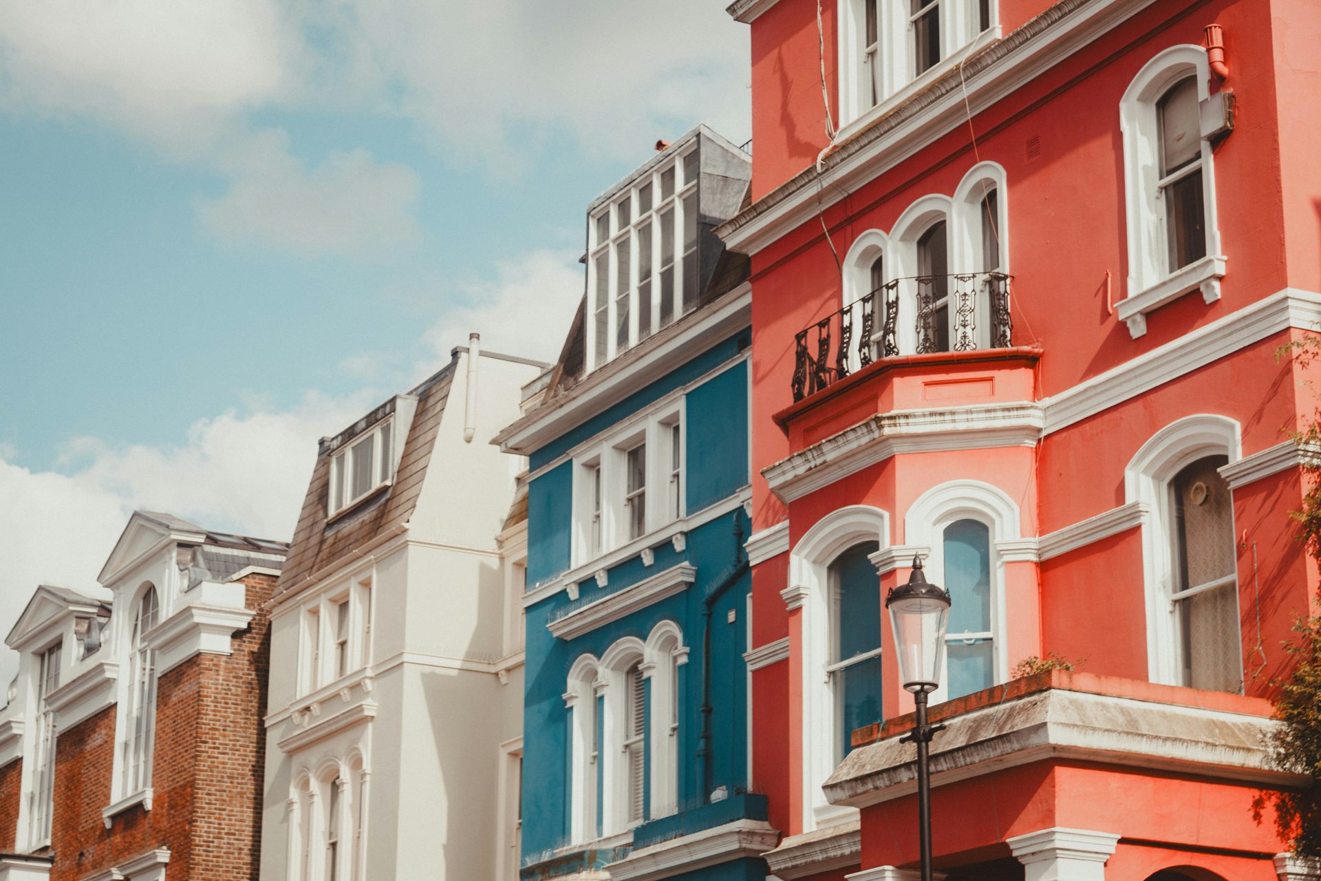 A row of multi - colored buildings on a city street